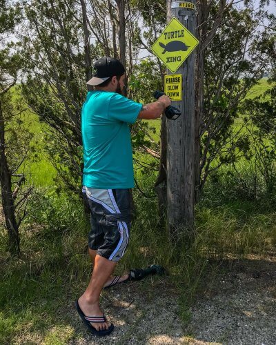 Chris Leone mounting a turtle crossing sign